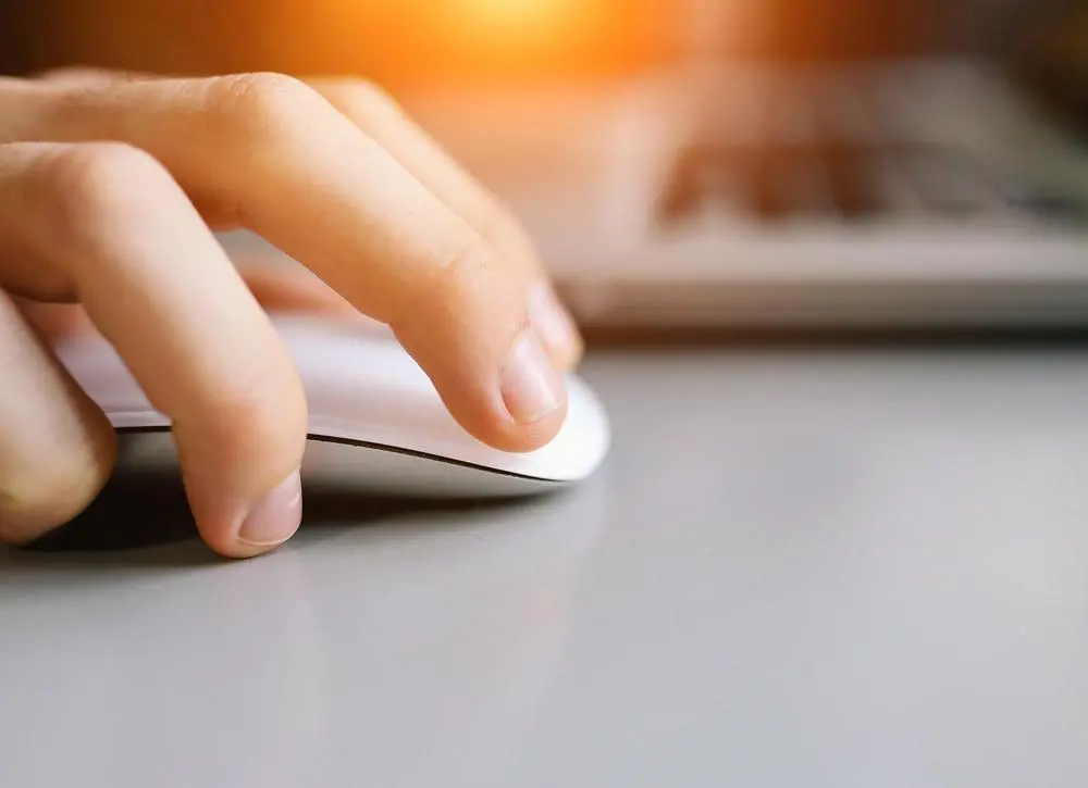 closeup of hand holding computer mouse